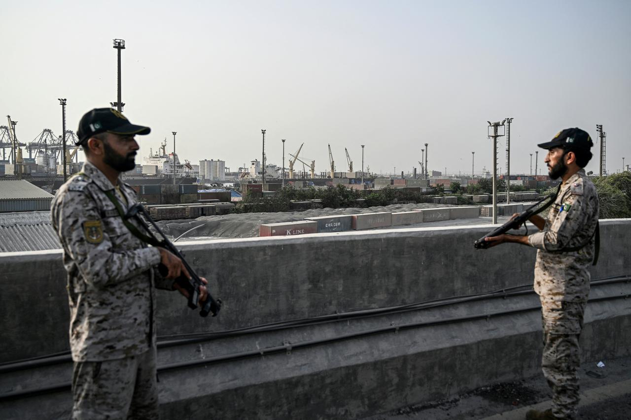 Indian army personnel stand next to explosives, carried by a drone, after it was intercepted by the Indian air defence system, on the outskirts of Amritsar, on May 10, 2025. The Indian army on May 10 reported fresh Pakistani attacks along the border with its arch-foe as the conflict between the nuclear-armed neighbours spiralled. (Photo by Narinder NANU / AFP)