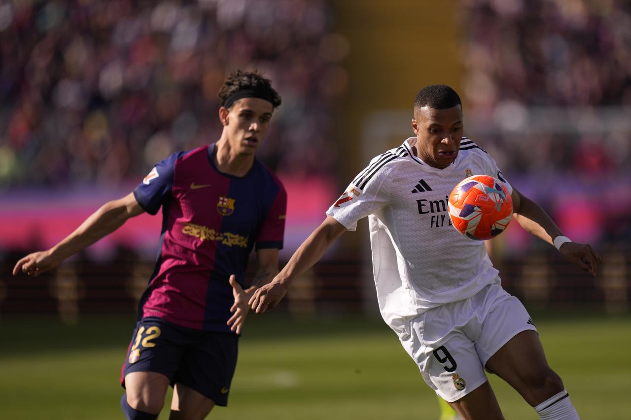 Kylian Mbappe centre-forward of Real Madrid and France and Hector Fort right-back of Barcelona and Spain compete for the ball during the La Liga match between FC Barcelona and Real Madrid at Estadi Olimpic Lluis Companys on May 11, 2025 in Barcelona, Spain.  (AA Photo)