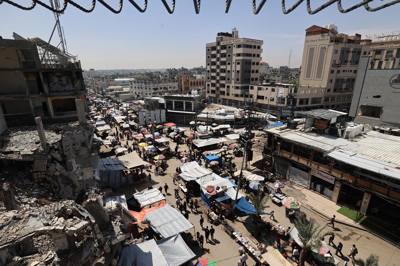 Palestinians gather at a market at the Nuseirat refugee camp in the central Gaza Strip on May 10, 2025. (AFP Photo)