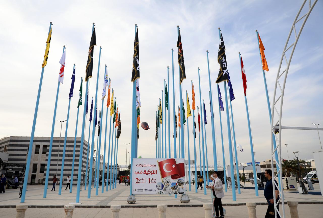 Flags of participating countries and companies are displayed at the entrance of the international construction, building materials, and energy exhibition in Damascus, Syria, May 11, 2025. (AA Photo)