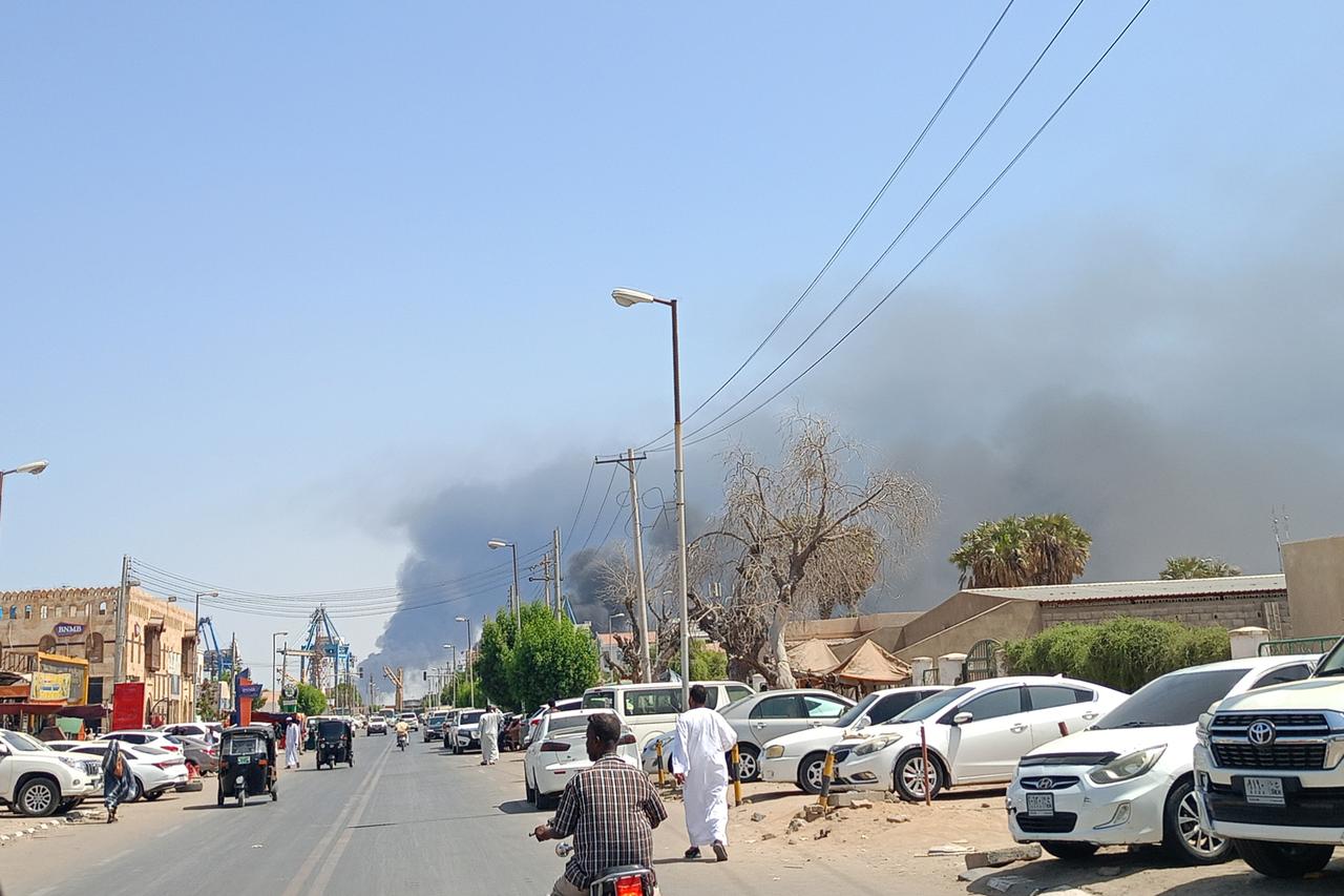 Smoke billows after a drone strike on the port of Port Sudan on May 6, 2025. Drones struck the airport and targeted an army base in Port Sudan on May 6, officials said, the third straight day the Sudanese army-aligned governments seat of power has come under attack. (Photo by AFP)