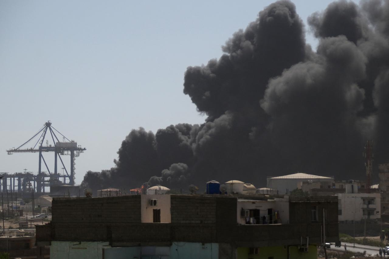 Smoke billows after a drone strike on the port of Port Sudan on May 6, 2025. Drones struck the airport and targeted an army base in Port Sudan on May 6, officials said, the third straight day the Sudanese army-aligned governments seat of power has come under attack. (Photo by AFP)