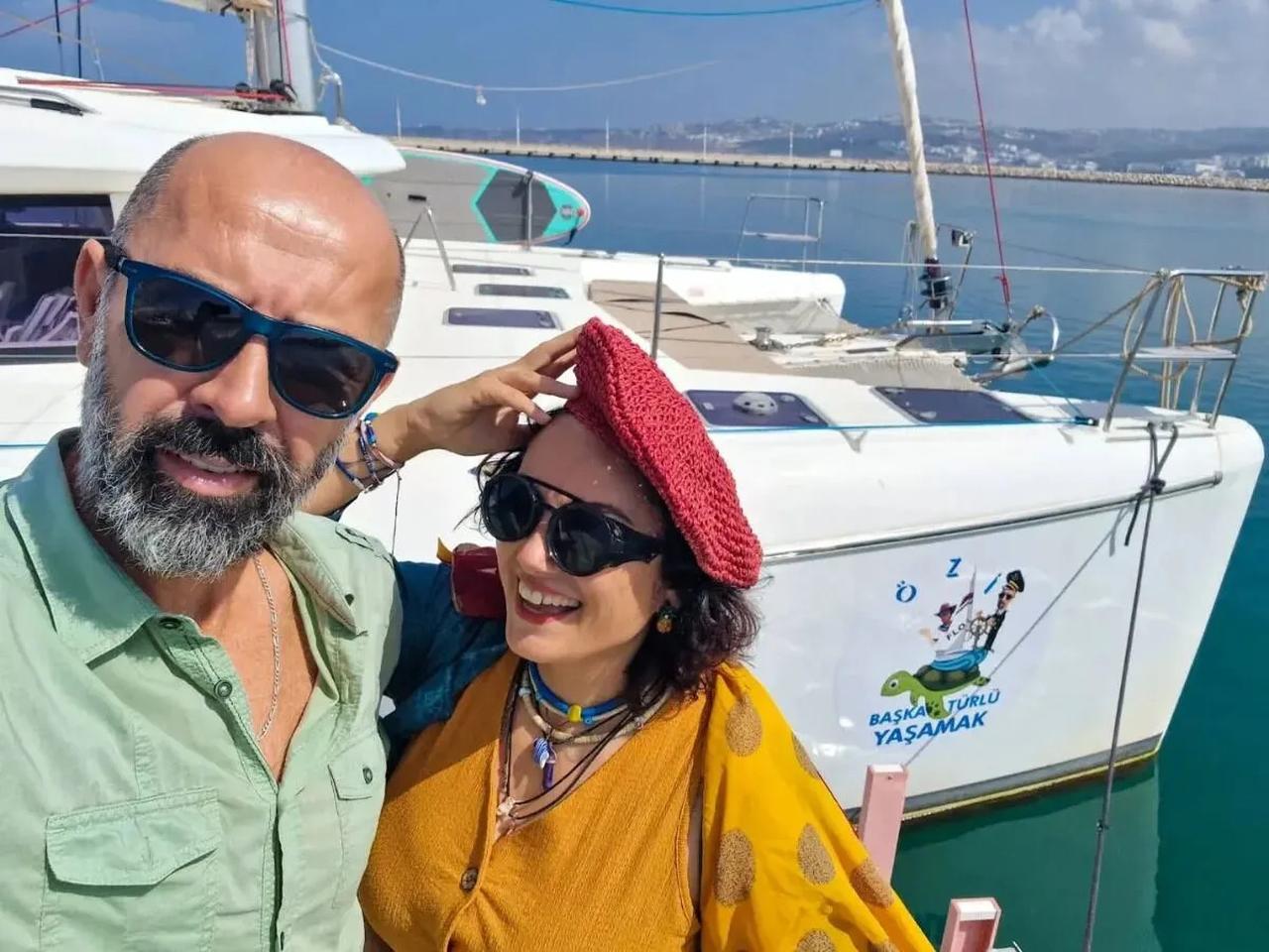 Experienced Turkish sailors Ozkan and Ozlem Sahin pose with their catamaran Ozi. (Photo via Patronlar Dunyasi)