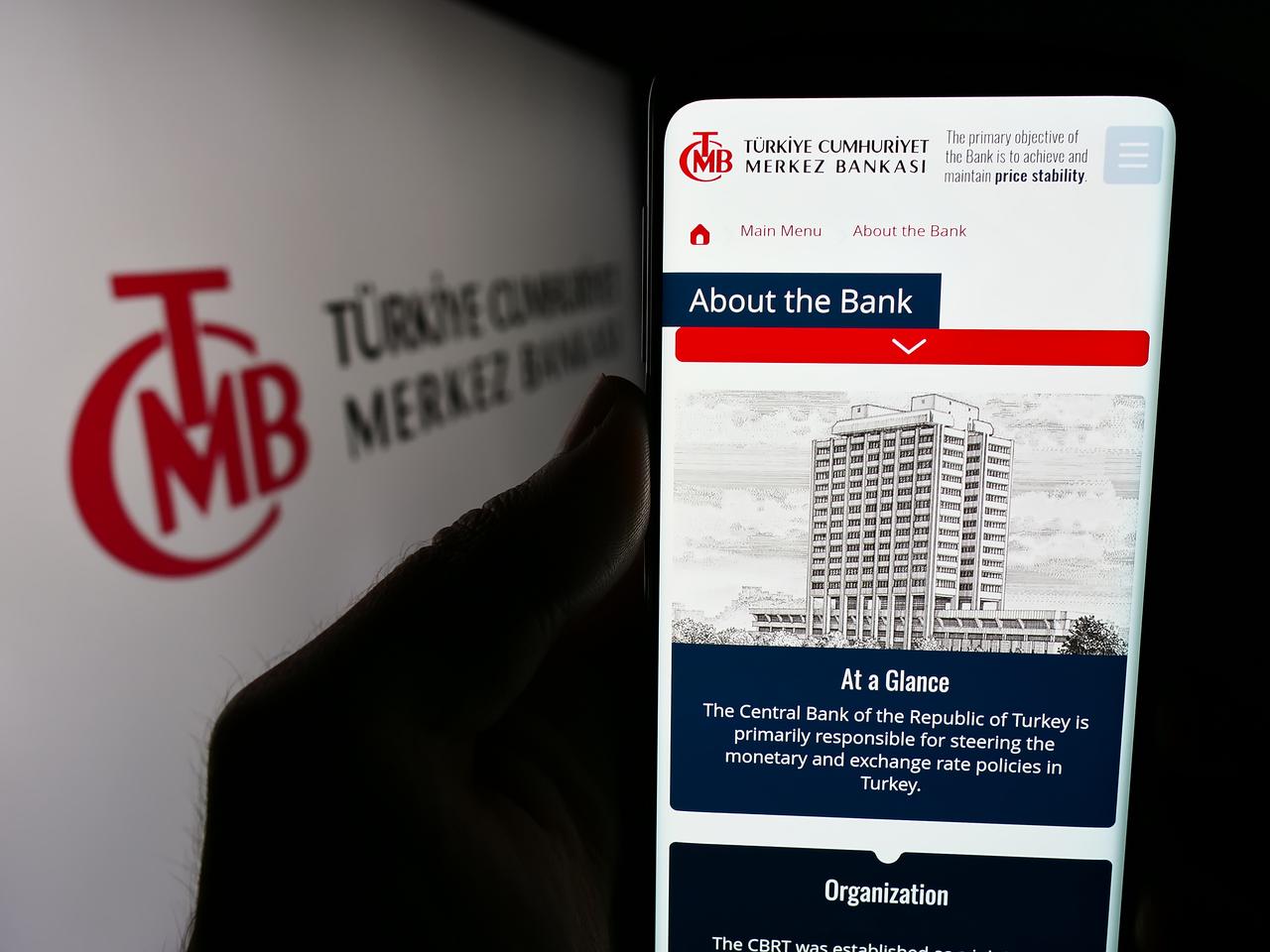A person holding a smartphone showing the Central Bank of the Republic of Türkiye’s (CBRT) official website in Stuttgart, Germany, accessed on June 24, 2024. (Adobe Stock Photo)