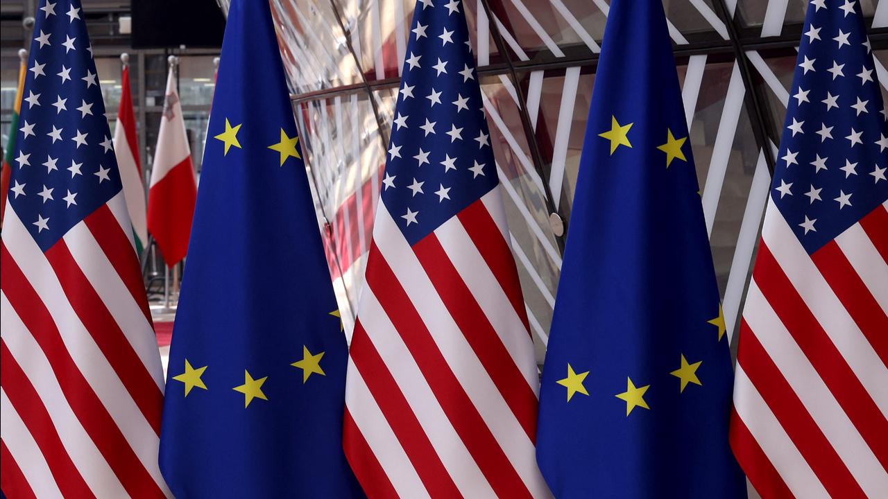 This photograph shows European flags outside the EU headquarters in Brussels on May 6, 2025. (Photo by Nicolas TUCAT / AFP)