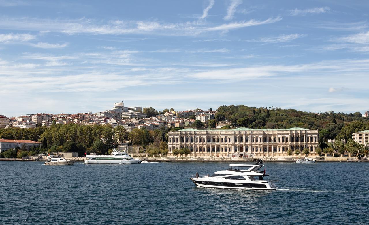View of a yacht passing by historical palace on Bosphorus and European side of Istanbul. (Adobe Stock Photo)