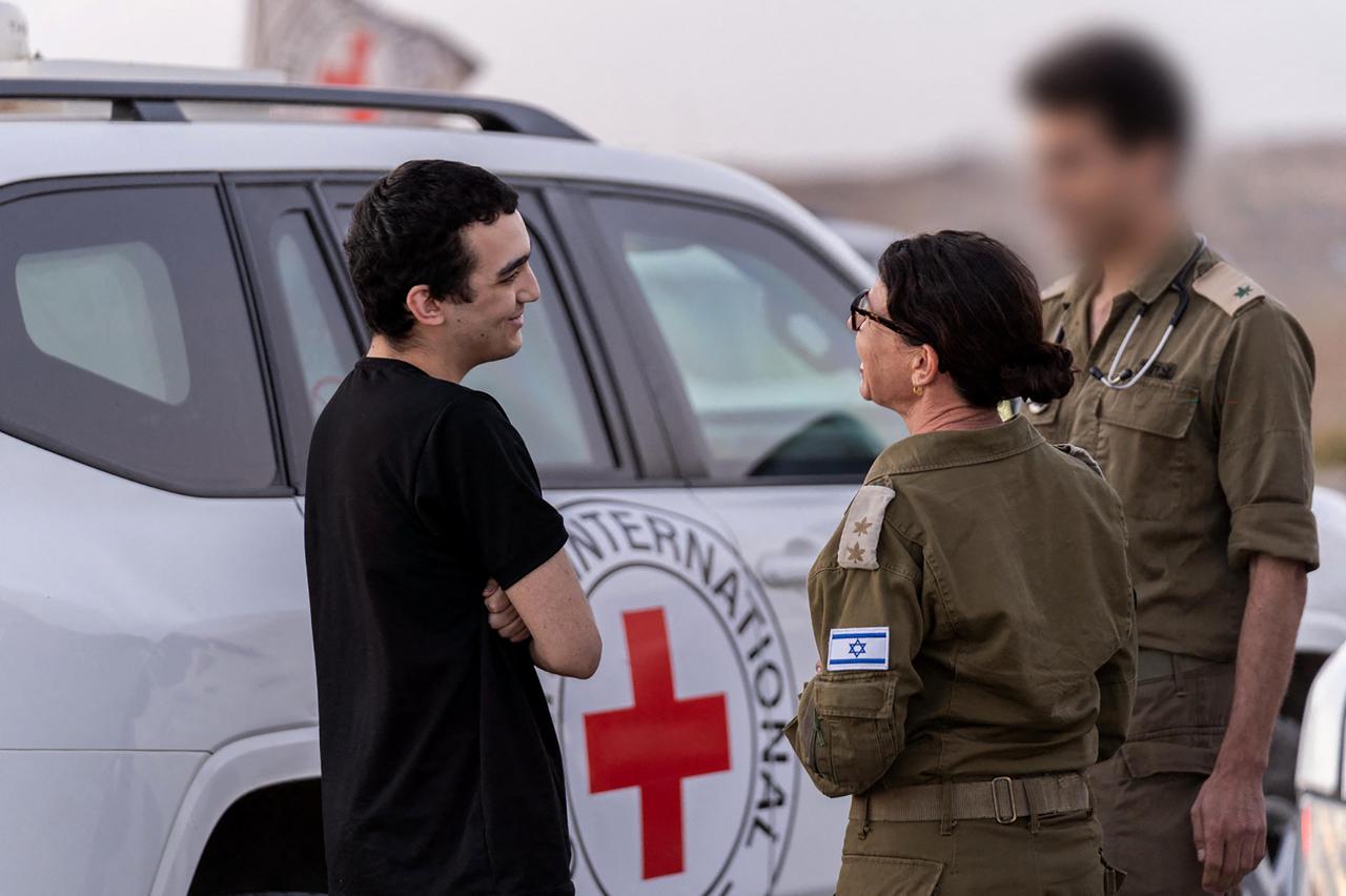 This handout picture released by the Israeli government press office (GPO) shows newly-released Israeli-US hostage Edan Alexender talking to Israeli soldiers near a Internation Red Cross vehicle, at an undisclosed location, May 12, 2025. (AFP Photo)