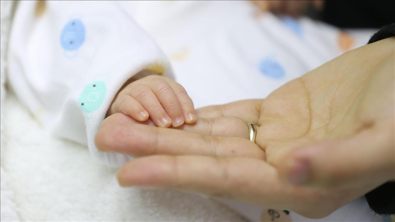 A mother gently holds her newborn’s hand in Türkiye, accessed on May 13, 2025. (AA Photo)