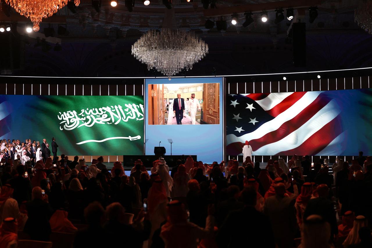 People look to a giant screen as US President Donald Trump and Saudi Crown Prince Mohammed bin Salman arrive for the Saudi-US investment forum at the King Abdul Aziz International Conference Center in Riyadh on May 13, 2025. (AFP Photo)