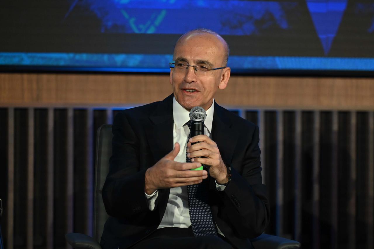 Turkish Treasury and Finance Minister Mehmet Simsek delivers a presentation on the Turkish economy and answers questions during the session titled "Turkiye’s Economic Transformation and Growing Investment Potential" held as part of the European Bank for Reconstruction and Development (EBRD) Annual Meetings in London, United Kingdom, on May 14, 2025. (AA Photo)