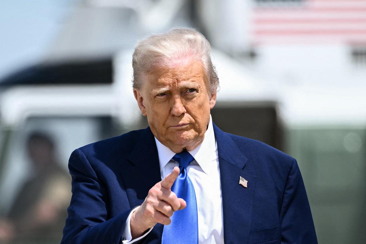 US President Donald Trump gestures as he walks to board Air Force One at Joint Base Andrews in Maryland on May 12, 2025. (AFP Photo)