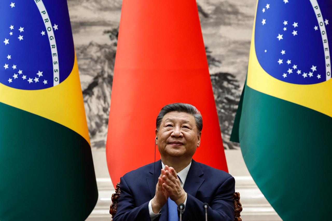 Chinese President Xi Jinping applauds after a joint press conference with Brazil's President Luiz Inacio Lula da Silva (not pictured) at the Great Hall of the People in Beijing on May 13, 2025. (AFP Photo)