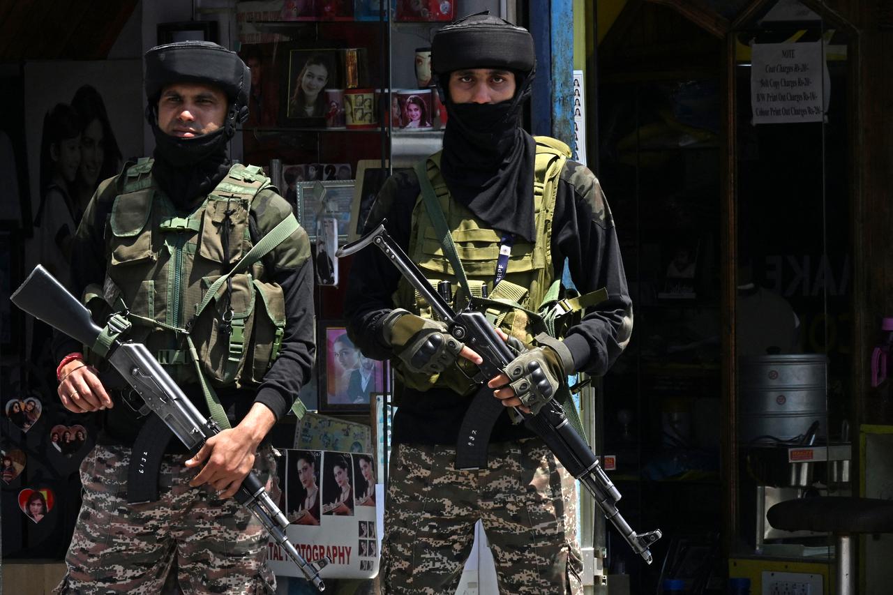 Indian paramilitary troopers stand guard along a street in Srinagar on May 15, 2025. (AFP Photo)