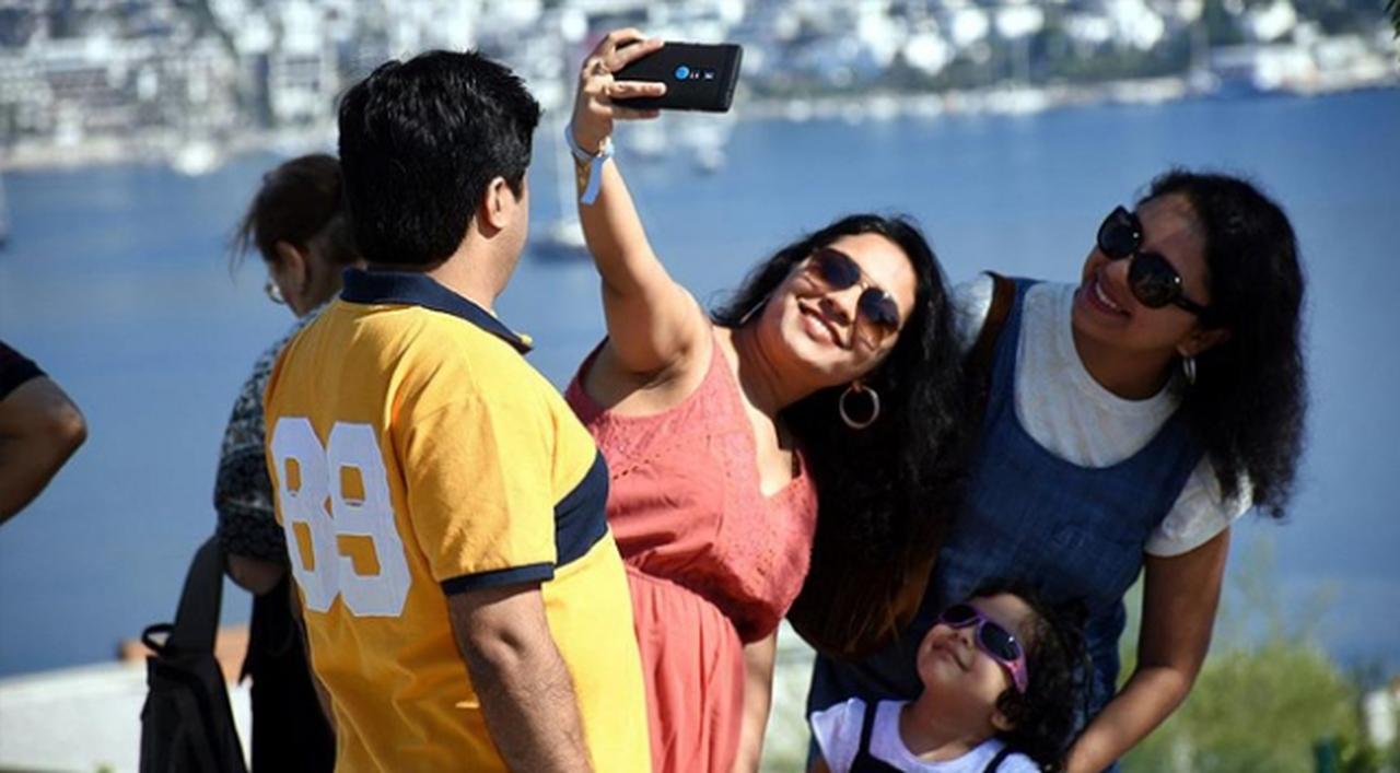 Indian tourists pose for a cheerful selfie with scenic views of Bodrum in Mugla, Türkiye, accessed on May 15, 2025. (AA Photo)