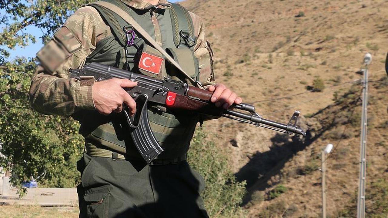 A security guard in uniform holding a weapon (AA Photo)