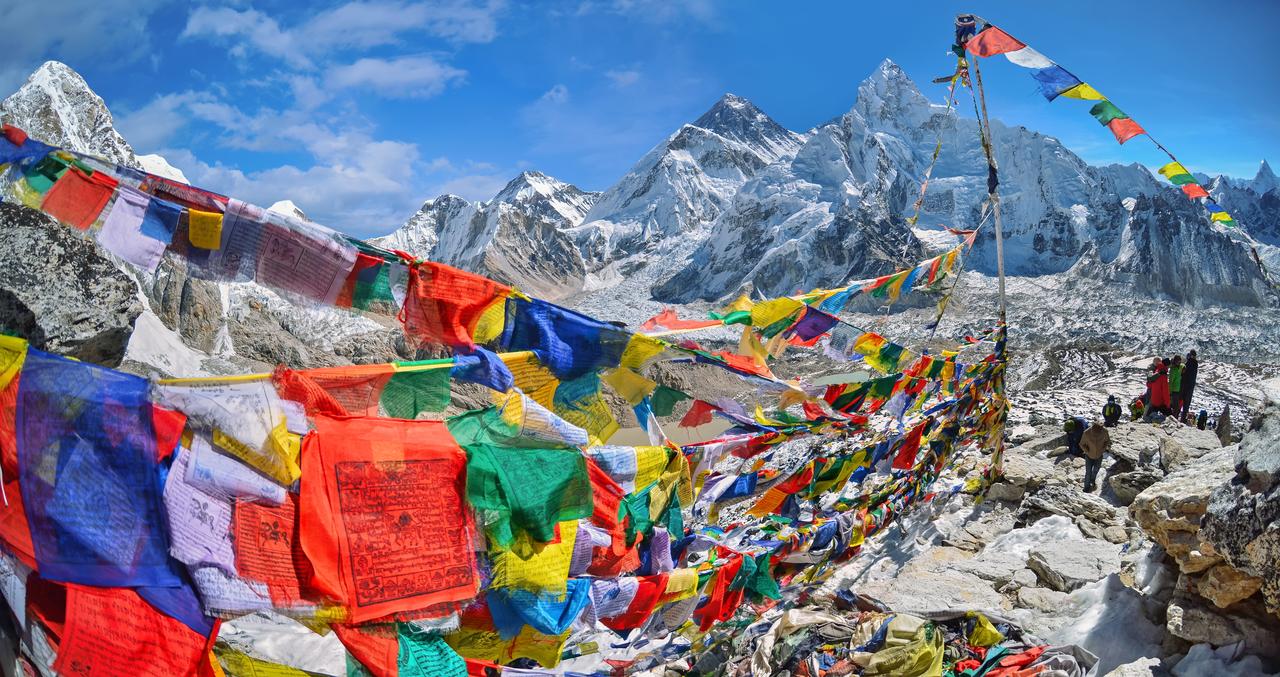 A view of Mount Everest and Nuptse with buddhist prayer flags from kala patthar in Sagarmatha National Park in Nepal Himalaya. (Adobe Stock Photo)