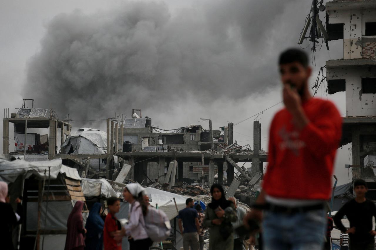 Smoke billows in the background as an Israeli strike hits the home of the Hmeid family in Jabalia in the northern Gaza Strip on May 15, 2025. Fighting has raged in Gaza, where civil defence officials told AFP 80 people were killed by Israeli bombardment on May 14, including 59 in the north. (Photo by Bashar TALEB / AFP)