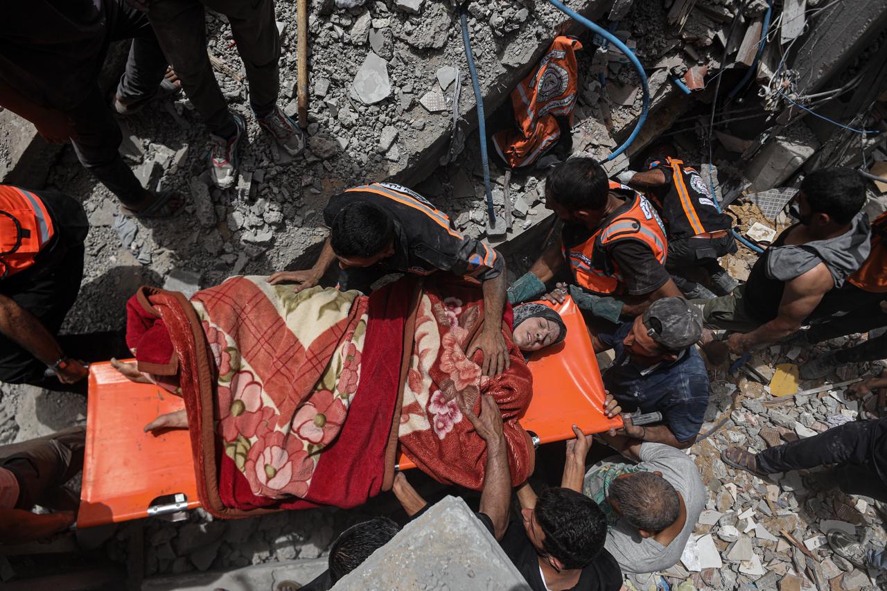 Civil Defense teams and residents of the region carry out search and rescue operations in the area where the Israeli attack took place on the Jabalia area in the northern Gaza Strip on May 17, 2025. During the search and rescue operations, a Palestinian woman was rescued alive from under the rubble. (AA Photo)