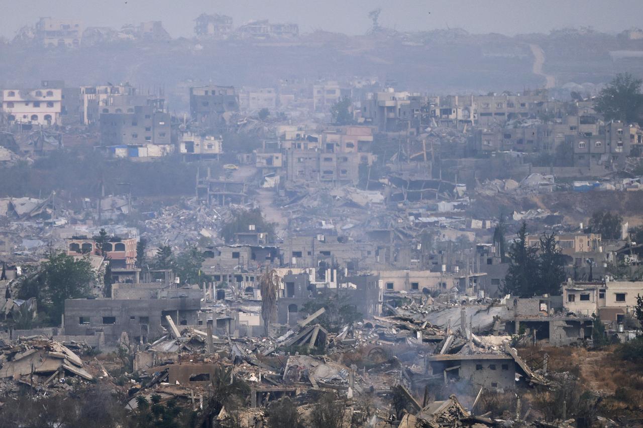 A picture taken from a position at the Israeli border with the Gaza Strip shows the destruction due to Israeli bombardment in the besieged Palestinian territory on May 18, 2025. Gazas civil defence agency said Israeli air strikes on May 18 killed at least 33 people, more than half of them children, a day after Israel announced an expanded military campaign. (Photo by Menahem KAHANA / AFP)