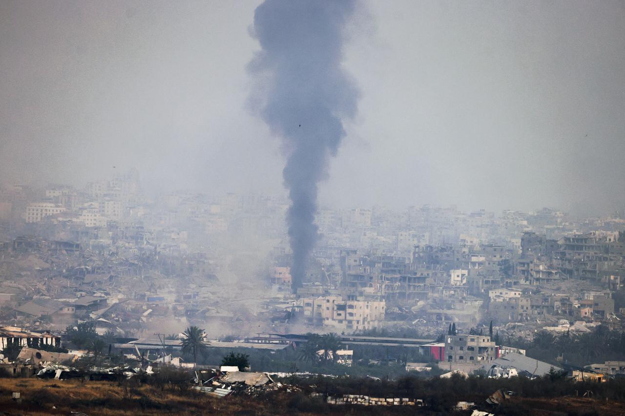 A picture taken from a position at the Israeli border with the Gaza Strip shows smoke billowing due to Israeli bombardment in the besieged Palestinian territory on May 18, 2025. Gazas civil defence agency said Israeli air strikes on May 18 killed at least 33 people, more than half of them children, a day after Israel announced an expanded military campaign. (Photo by Menahem KAHANA / AFP)