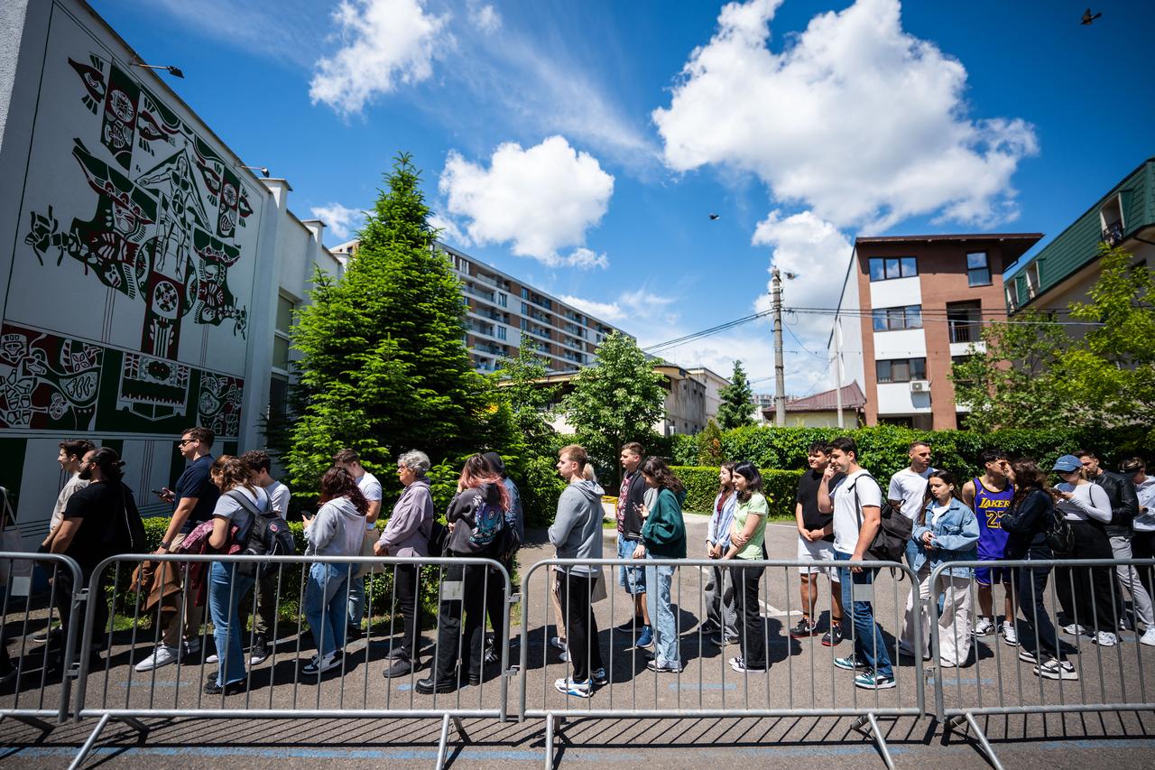 Students wait in line to vote at a polling station in Bucharest, Romania on May 18, 2025, during the second round of the presidential elections. Romanians began voting Sunday in the second round of a presidential election rerun after last years vote was annulled over allegations of election interference. (Photo by Mihai Barbu / AFP)