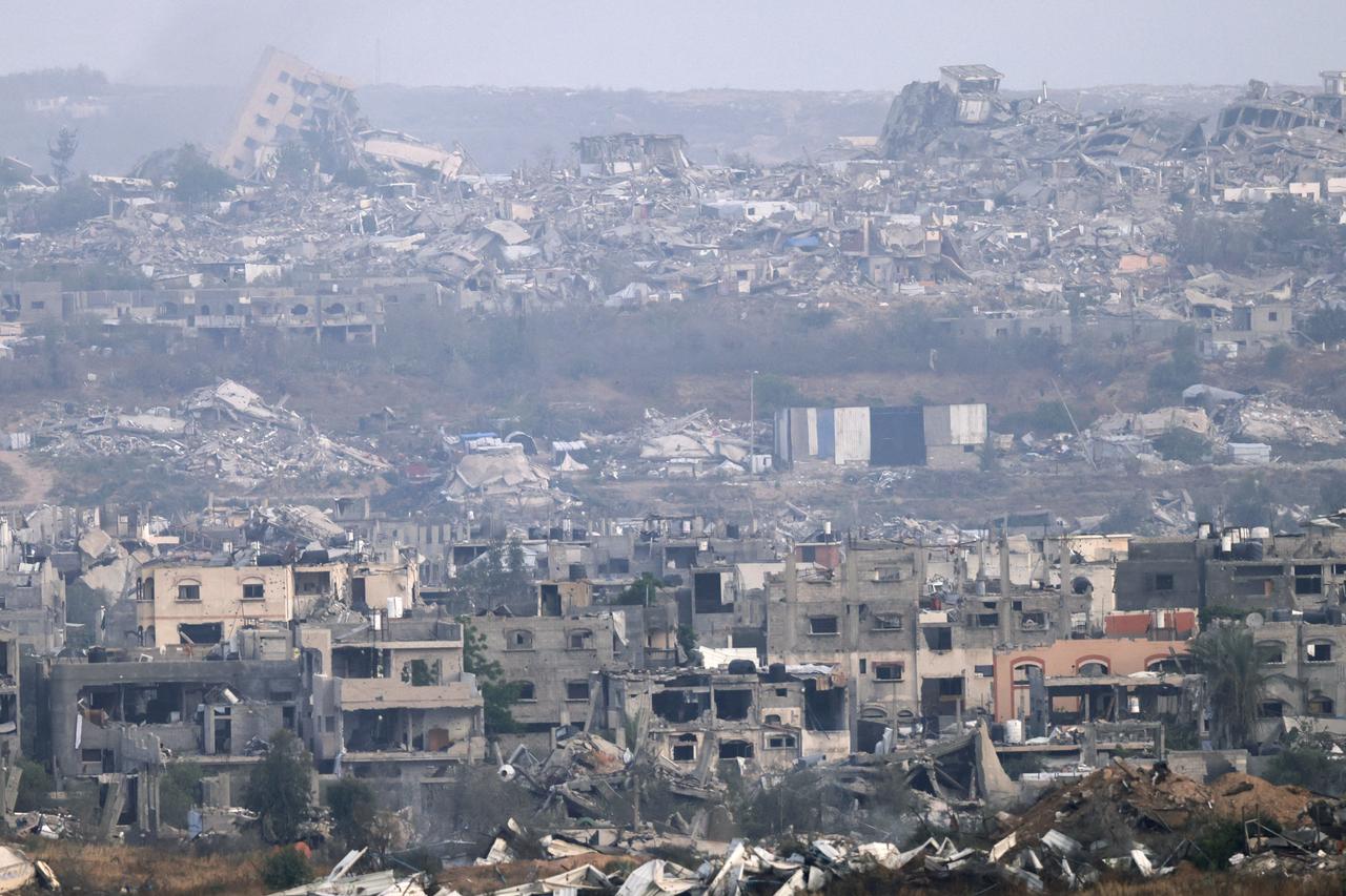 A picture taken from a position at the Israeli border with the Gaza Strip shows the destruction due to Israeli bombardment in the besieged Palestinian territory on May 18, 2025. Gazas civil defence agency said Israeli air strikes on May 18 killed at least 33 people, more than half of them children, a day after Israel announced an expanded military campaign. (Photo by Menahem KAHANA / AFP)