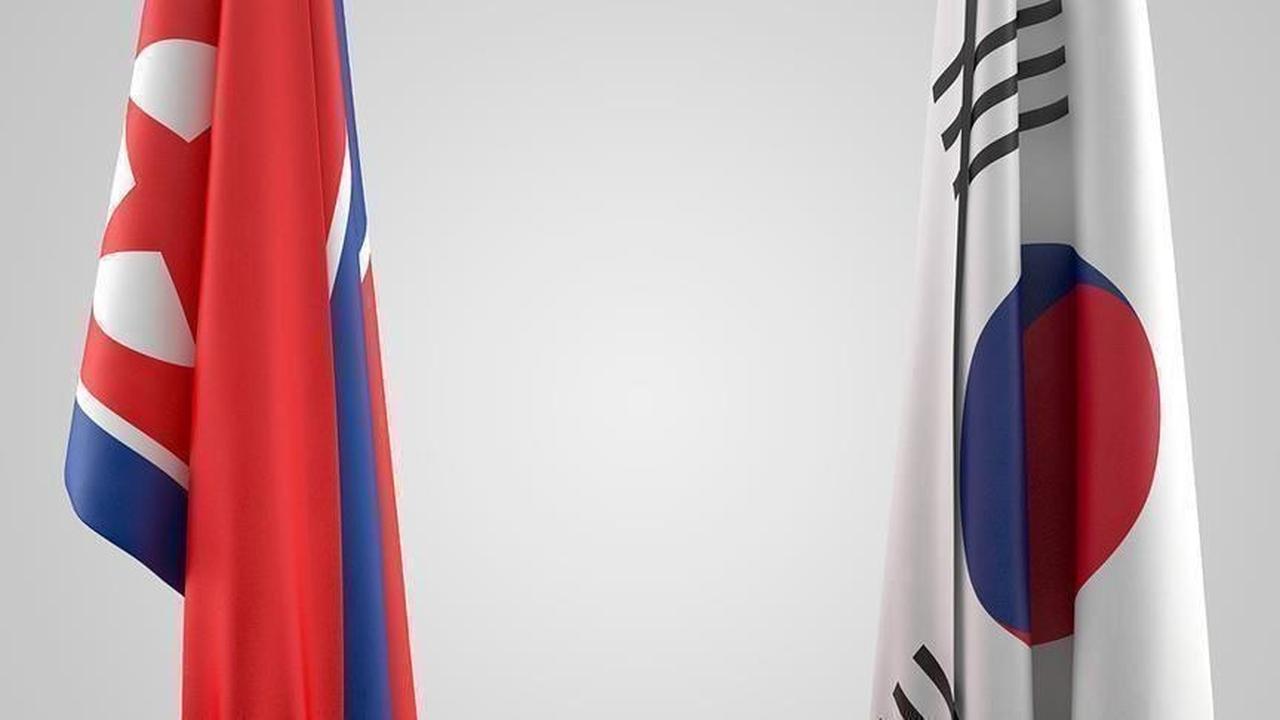 The Democratic Peoples Republic of Koreas flag on the left and Republic of Koreas flag on the right. (AA Photo)