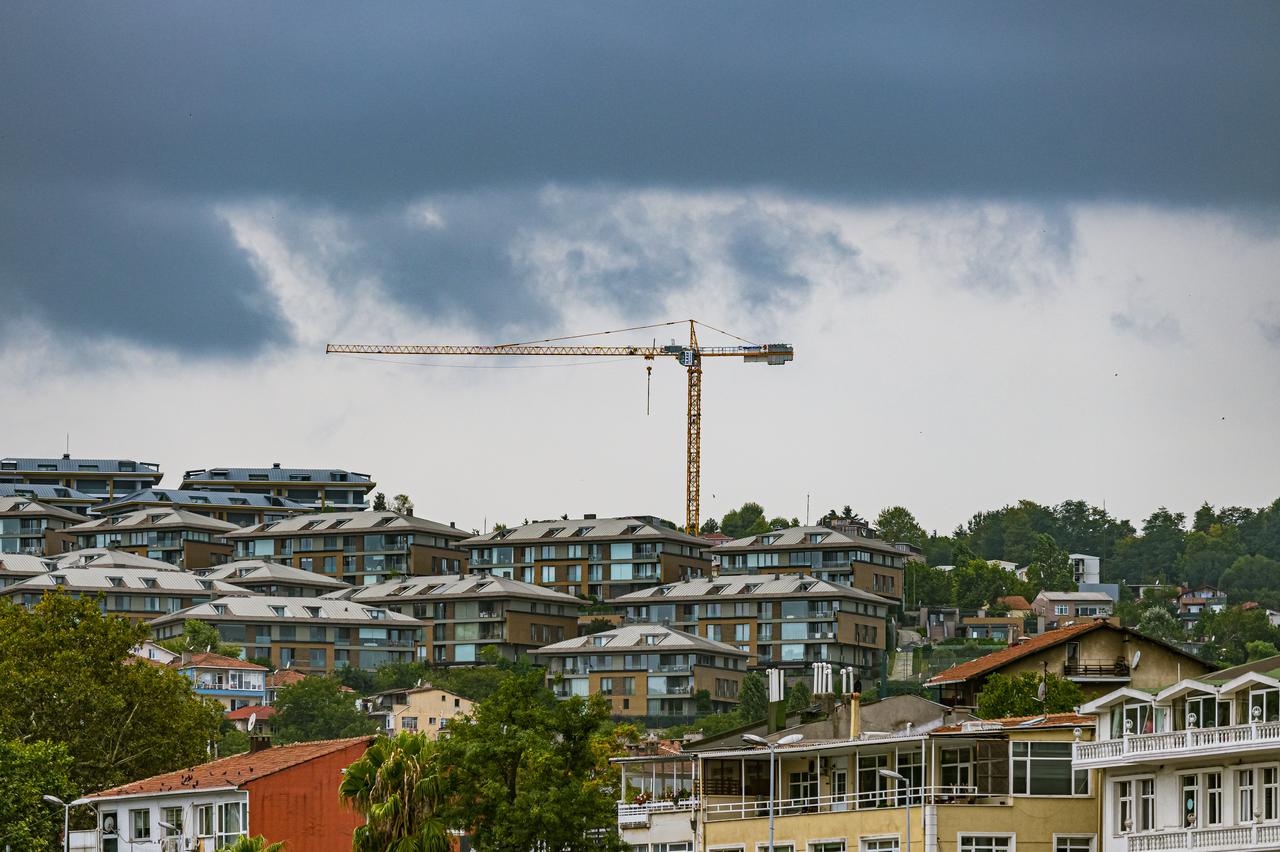 A construction crane stands over a residential district in Istanbul, Türkiye, on July 24, 2022. (Adobe Stock Photo)