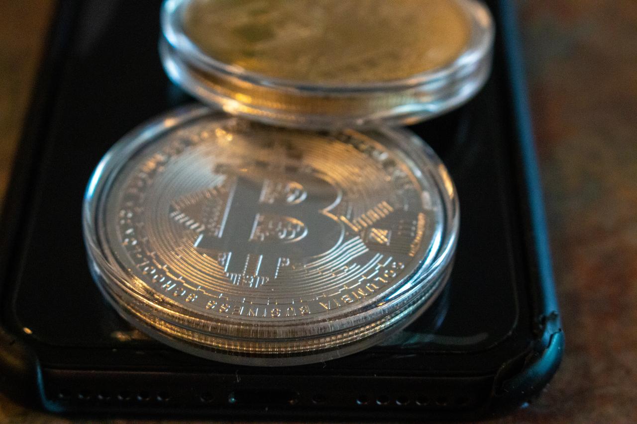Physical representations of Bitcoin rest on a smartphone in London, Canada, on January 24, 2020. (Adobe Stock Photo)