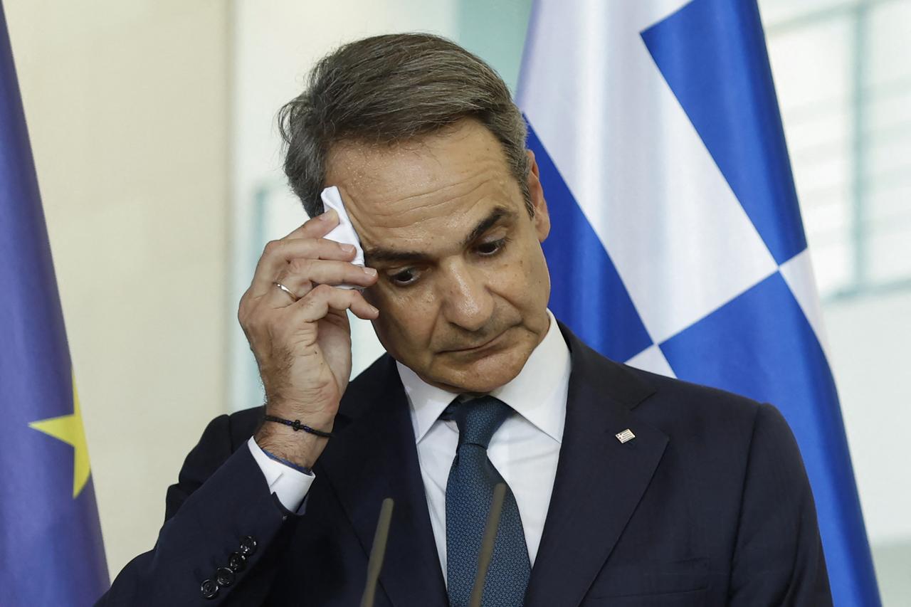 Greek Prime Minister Kyriakos Mitsotakis wipes his forehead as the German chancellor addresses a joint press conference after talks at the Chancellery in Berlin on May 13, 2025. (AFP Photo)