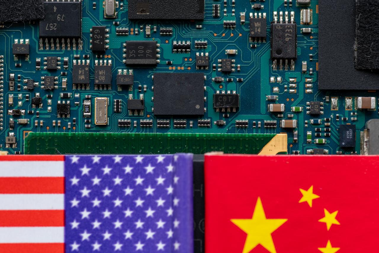 Close-up of a circuit board framed by U.S. and Chinese flags, illustrating the growing technological rivalry between the two nations, accessed on May 22, 2025. (Adobe Stock Photo)