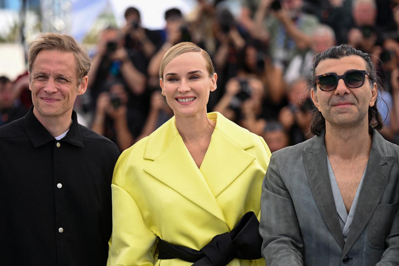 German actor Matthias Schweighofer, German actress Diane Kruger and German director and screenwriter Fatih Akin pose during a photocall for the film  Amrum  at the 78th edition of the Cannes Film Festival in Cannes, southern France, on May 16, 2025. (Photo by Bertrand GUAY / AFP)