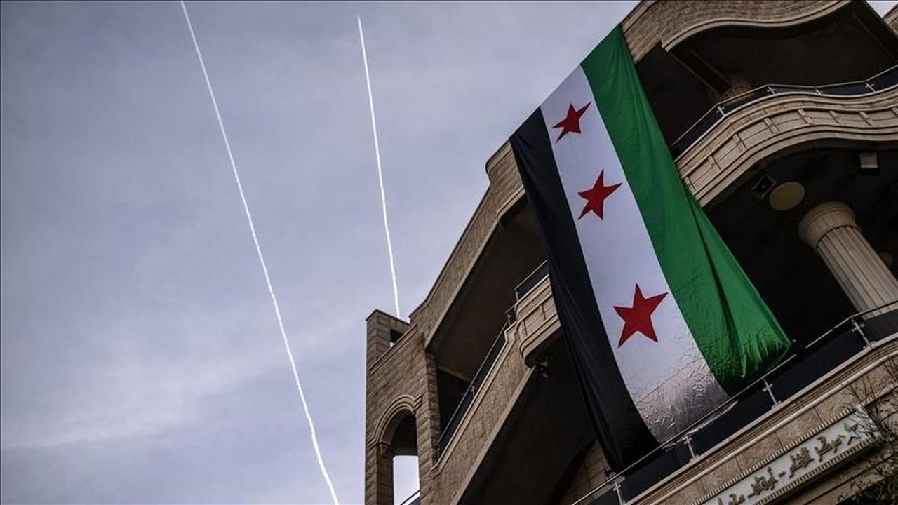 A large Syrian opposition flag hangs from a building in Damascus, Syria, accessed on May 23, 2025. (AA Photo)