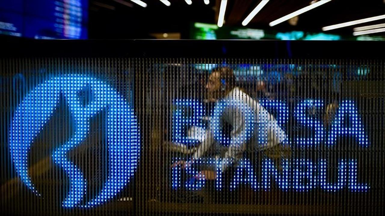 File photo shows a trader behind the illuminated Borsa Istanbul board in Istanbul, Türkiye, accessed on May 23, 2025. (AA Photo)