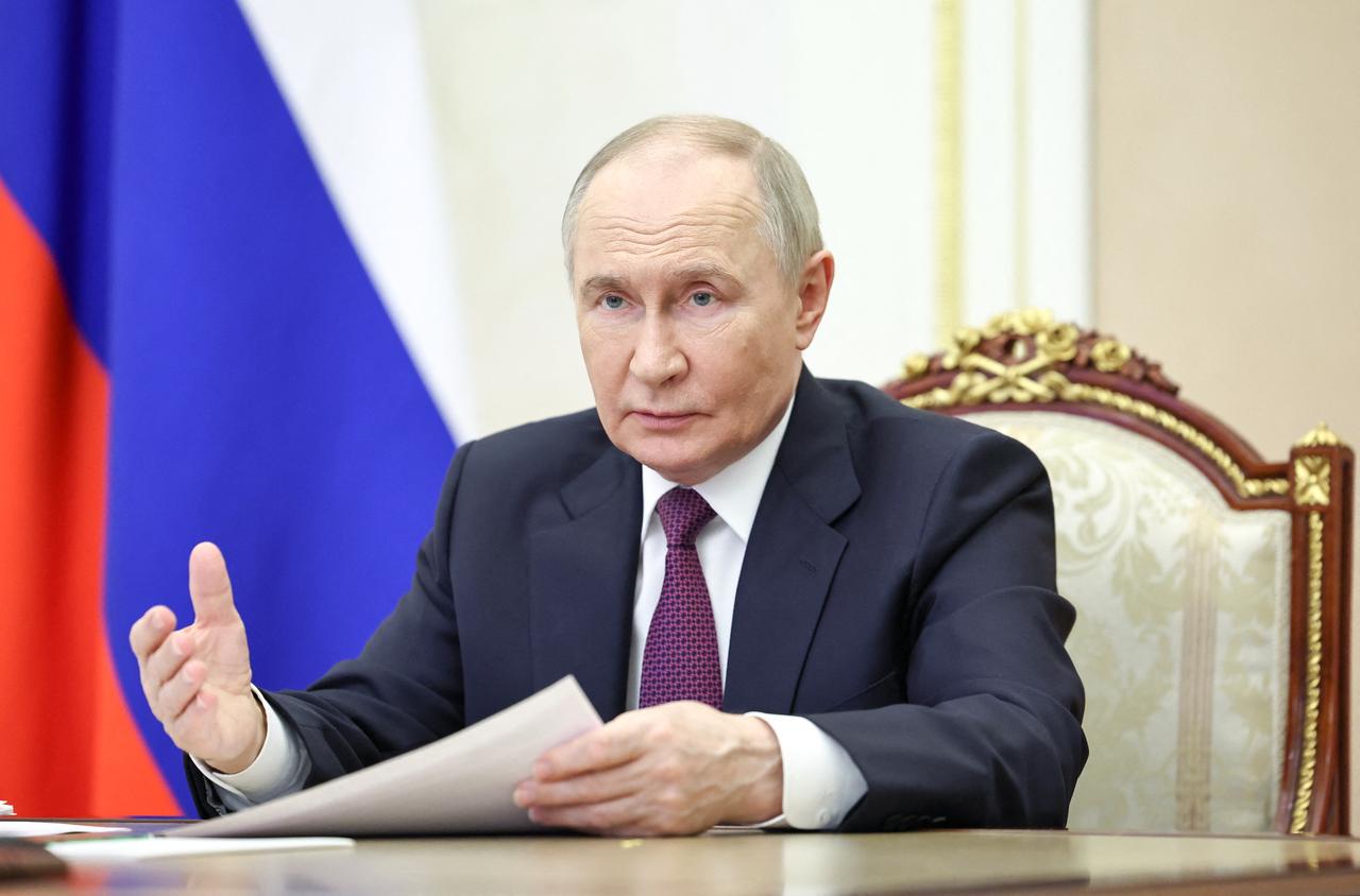 In this pool photograph distributed by the Russian state agency Sputnik, Russias President Vladimir Putin chairs a meeting with members of the government via a videoconference at the Kremlin in Moscow on May 22, 2025. (Photo by Alexander KAZAKOV / POOL / AFP)