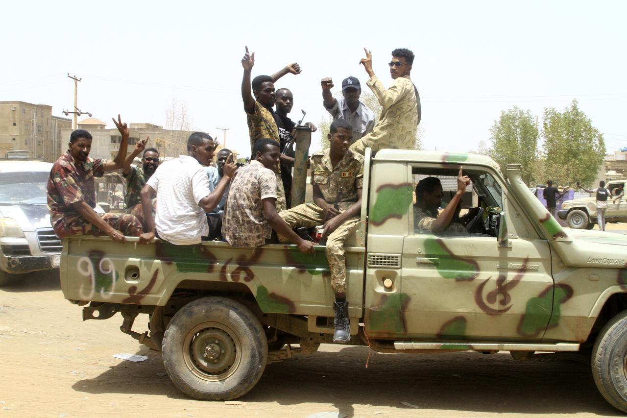 Sudanese army soldiers celebrate as they patrol in Salha, south of Omdurman, two days after the Sudanese army recaptured it from the paramilitary Rapid Support Forces (RSF), on May 22, 2025. The Sudanese army said on May 20 that it had dislodged rival paramilitaries from their last positions in Omdurman, part of the Sudanese capital, securing all of Khartoum state nearly two months after recapturing the capitals centre. (Photo by Ebrahim Hamid / AFP)