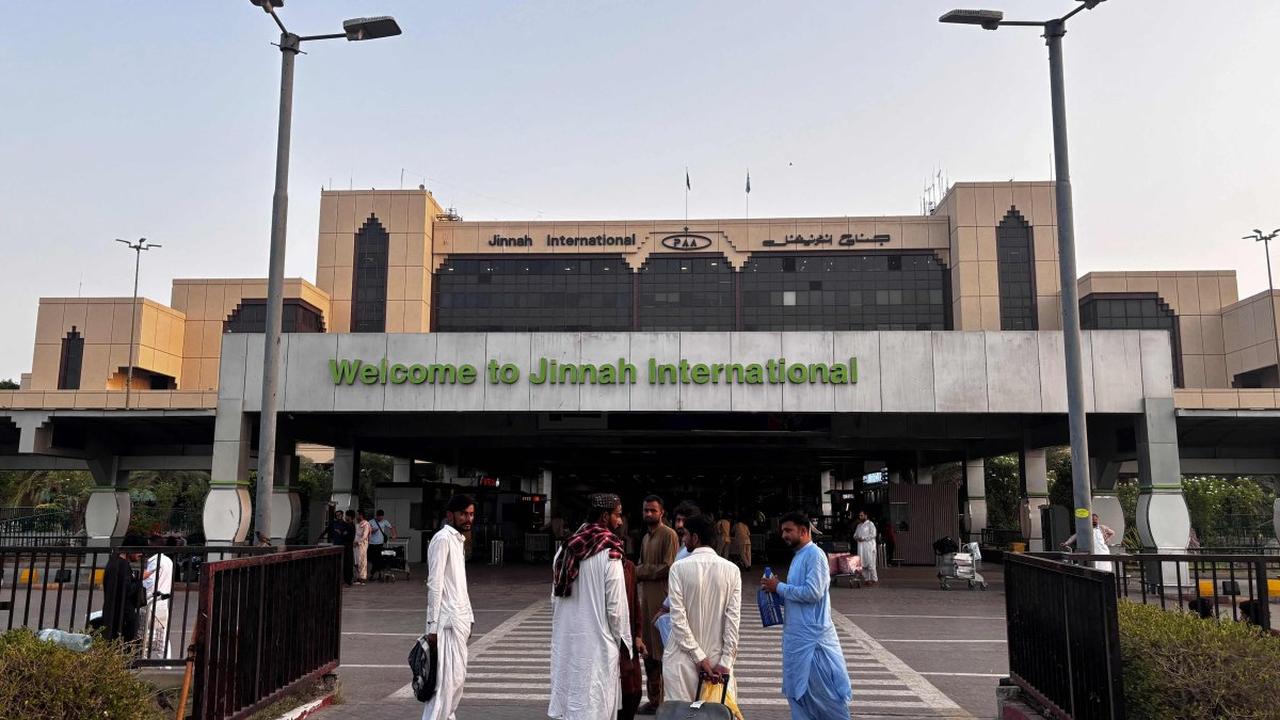 Passengers wait outside at Jinnah International Airport after all domestic and international flights were cancelled in Karachi, Pakistan, May 7, 2025. (AFP Photo)