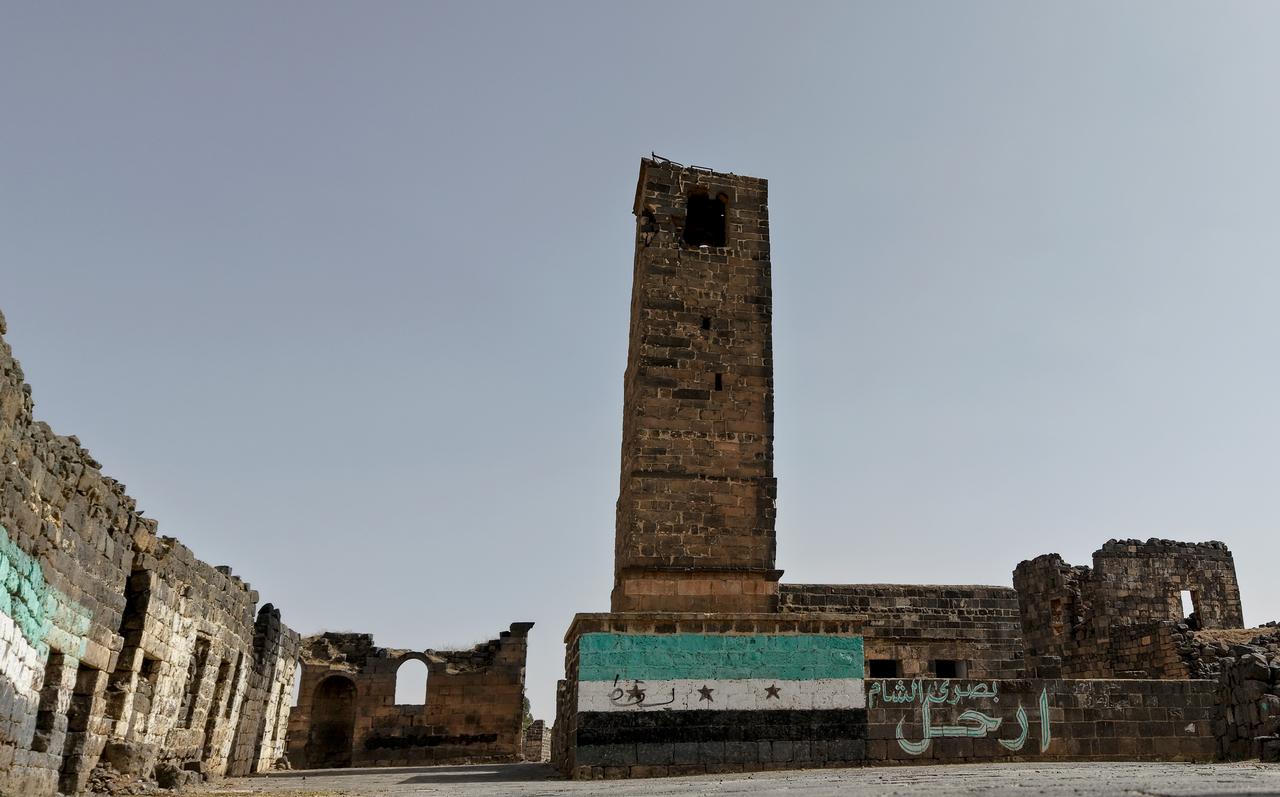 General view of the writings targeting the ousted Baath regime and its leader on the walls of damaged buildings and houses that were heavily damaged in regime attacks as daily life continues in Syrias Daraa, where the popular uprisings began in 2011 on May 17, 2025. (AA Photo) 