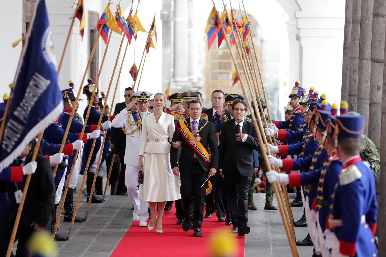 ARMANDO PRADOAFP Ecuador's re-elected President Daniel Noboa (C) and his wife, First Lady Lavinia Valbonesi (L), accompanied by the president's chief of protocol, Mario Gallegos (R), receive honors upon their entrance to the Carondelet Palace after his inauguration at the National Assembly in Quito on May 24, 2025. (AFP Photo)