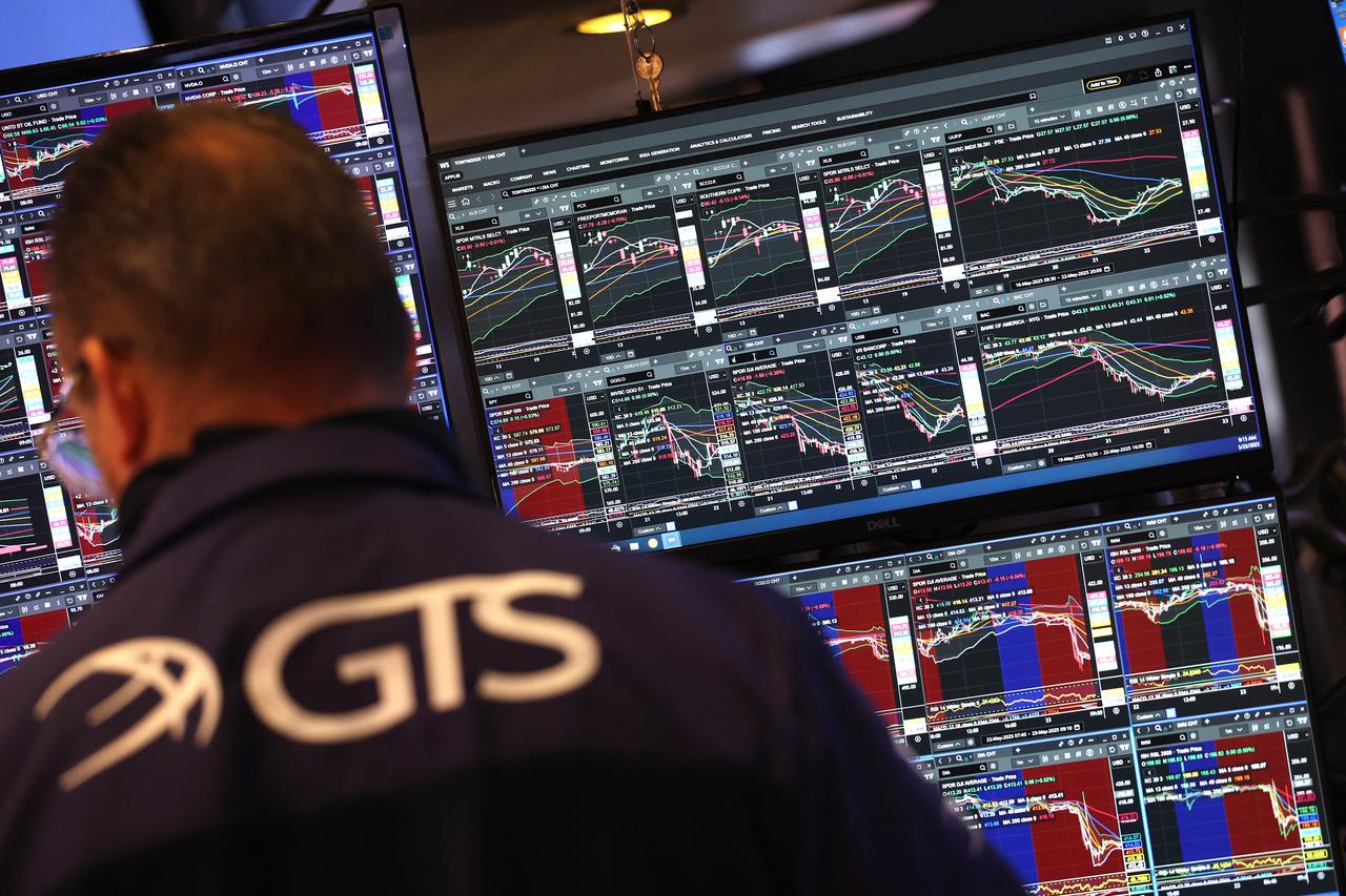 Traders work on the floor of the New York Stock Exchange (NYSE) at the opening bell on May 23, 2025, in New York City. Wall Street stocks opened lower May 23 after the opening bell, the S&P 500 was down 1.2 percent after US President Donald Trump warned of 50 percent tariffs on EU goods and 25 percent tariffs on Apple. (Photo by TIMOTHY A. CLARY / AFP)