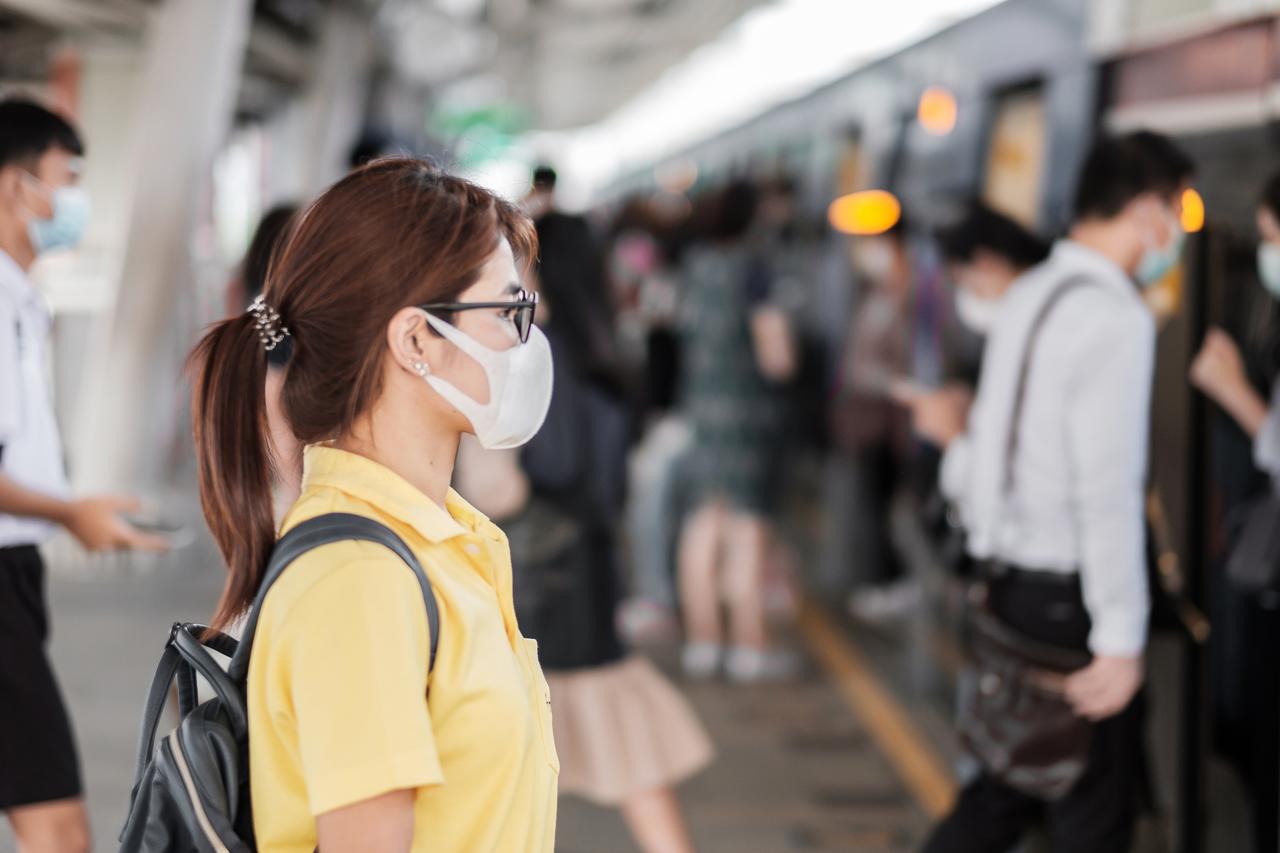 Young Asian woman wearing a protection mask against the novel coronavirus (2019-nCoV) at a public train station, China. (Adobe Stock Photo)