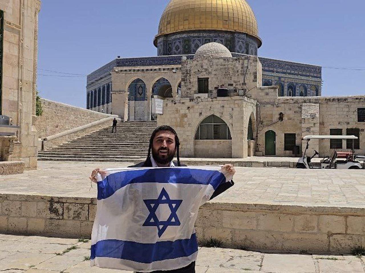 Ultranationalist Israeli lawmaker Zvi Sukkot displays Israel’s flag in front of Dome of the Rock inside courtyards of Al-Aqsa Mosque compound in occupied Jerusalem. (via Telegram)