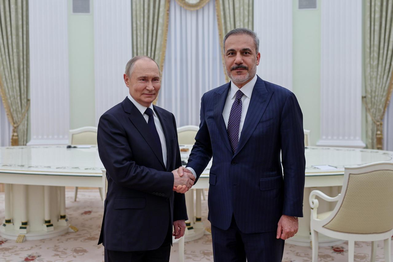 Foreign Minister Hakan Fidan (R) shakes hands with Russian President Vladimir Putin (L) as he is being received by Putin in Moscow, Russia on May 26, 2025. (AA Photo)