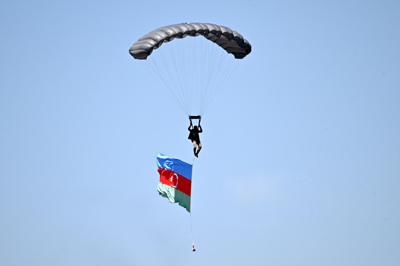 KAYSER?, TURKIYE - MAY 22: A paratrooper carrying the Azerbaijani flag descends during the Erciyes-2025 military drill in Kayseri, Turkiye on May 22, 2025. The exercise features the participation of international troops and includes airborne operations, tactical landings, and joint training activities. As part of the Erciyes-2025 drill scenario, 265 paratroopers jumped from C-130 and C-160 transport aircraft that took off from the 12th Air Transport Main Base Command, descending from an altitude of approximately 4,000 meters. A commemorative parachute jump was also held with the flags of 13 participating countries, including Azerbaijan, Bahrain, Bangladesh, Brazil, Georgia, Italy, Jordan, Libya, Pakistan, Rwanda, Saudi Arabia, Spain, and the United Arab Emirates. ( Sercan Küçük?ahin - Anadolu Agency )