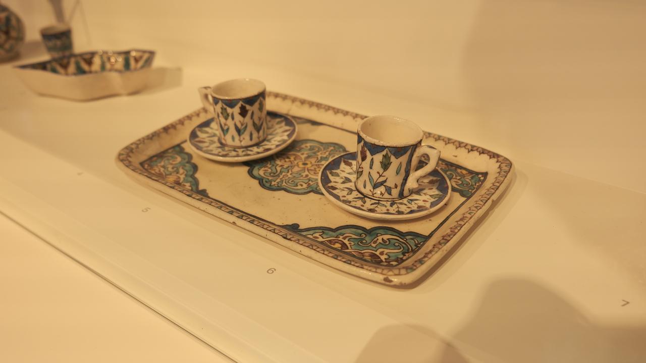 Artifacts from the “Iordanis Telaloglou's Coffeehouse” section of the exhibition "Extraordinary Minas: The Story of Inspiration and Innovation in Kutahya Tiles and Ceramics," on view at the Pera Museum in Istanbul, Türkiye, May 27, 2025. (Photo via Koray Erdogan/Türkiye Today)