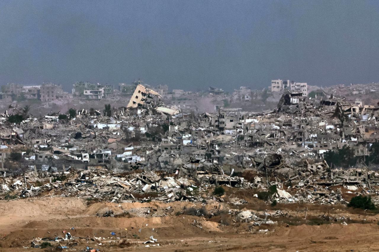 This picture taken from a position in southern Israel, on the border with the Gaza Strip, shows destroyed buildings in the besieged territory on May 27, 2025. Israeli Prime Minister Benjamin Netanyahu vowed May 26 to bring back all hostages,  living and dead , as Gaza rescuers said Israeli strikes killed at least 52 people in the war-battered Palestinian enclave. (Photo by Jack GUEZ / AFP)
