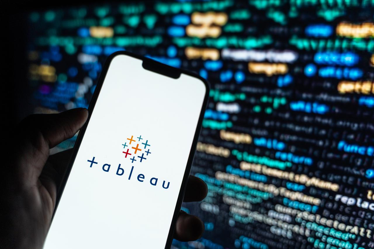 A hand holding a smartphone displaying the Tableau logo, accessed on May 28, 2025. (Adobe Stock Photo)