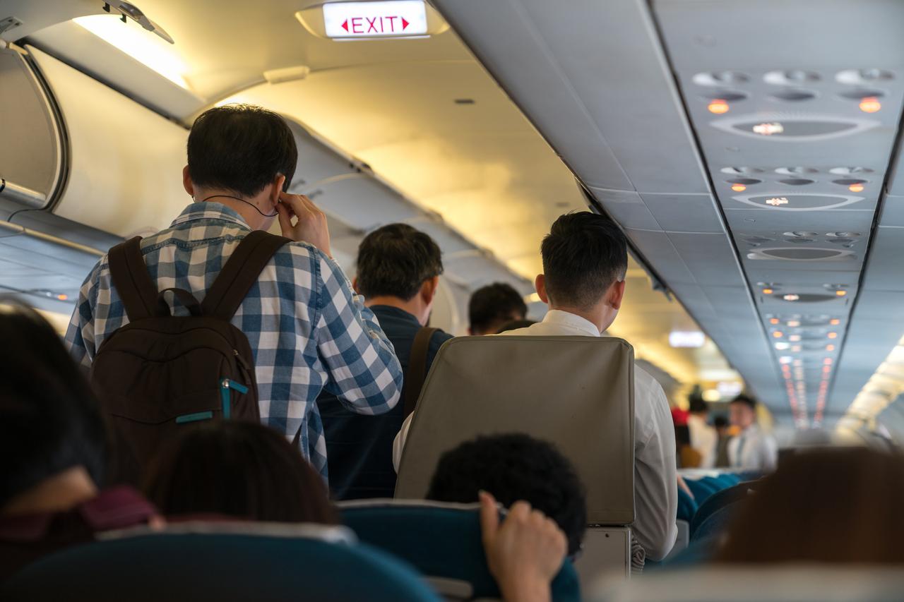 Photo shows people standing in an airplane cabin before disembarking, accessed on May 28, 2025. (Adobe Stock Photo)