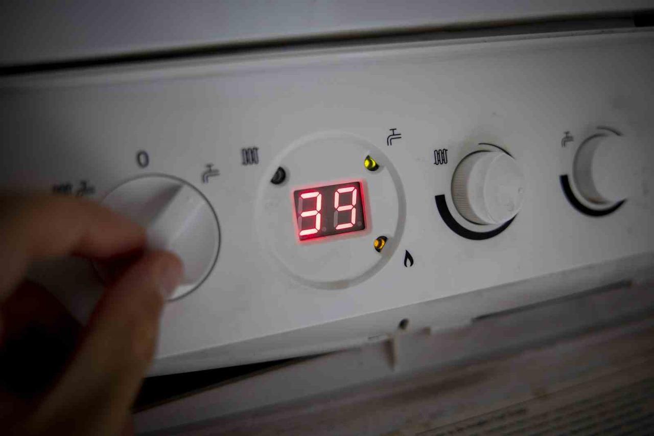 File photo shows a resident adjusts the settings on a household natural gas boiler in Türkiye, accessed on May 29, 2025. (IHA Photo)