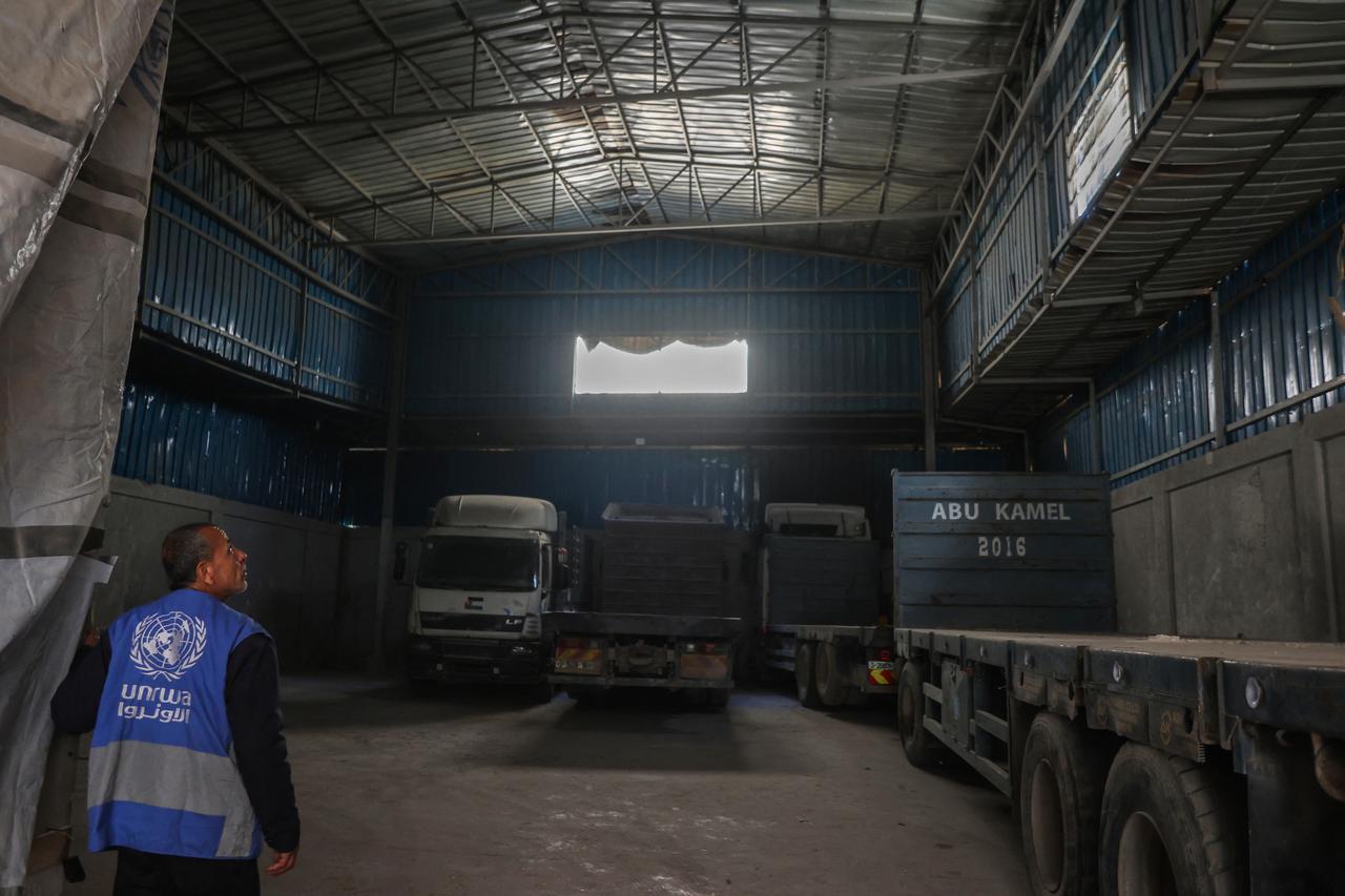 Palestinian children stand over empty containers at a food distribution centre in the Nuseirat camp for refugees, in the central Gaza Strip, on April 30, 2025. (AFP Photo)